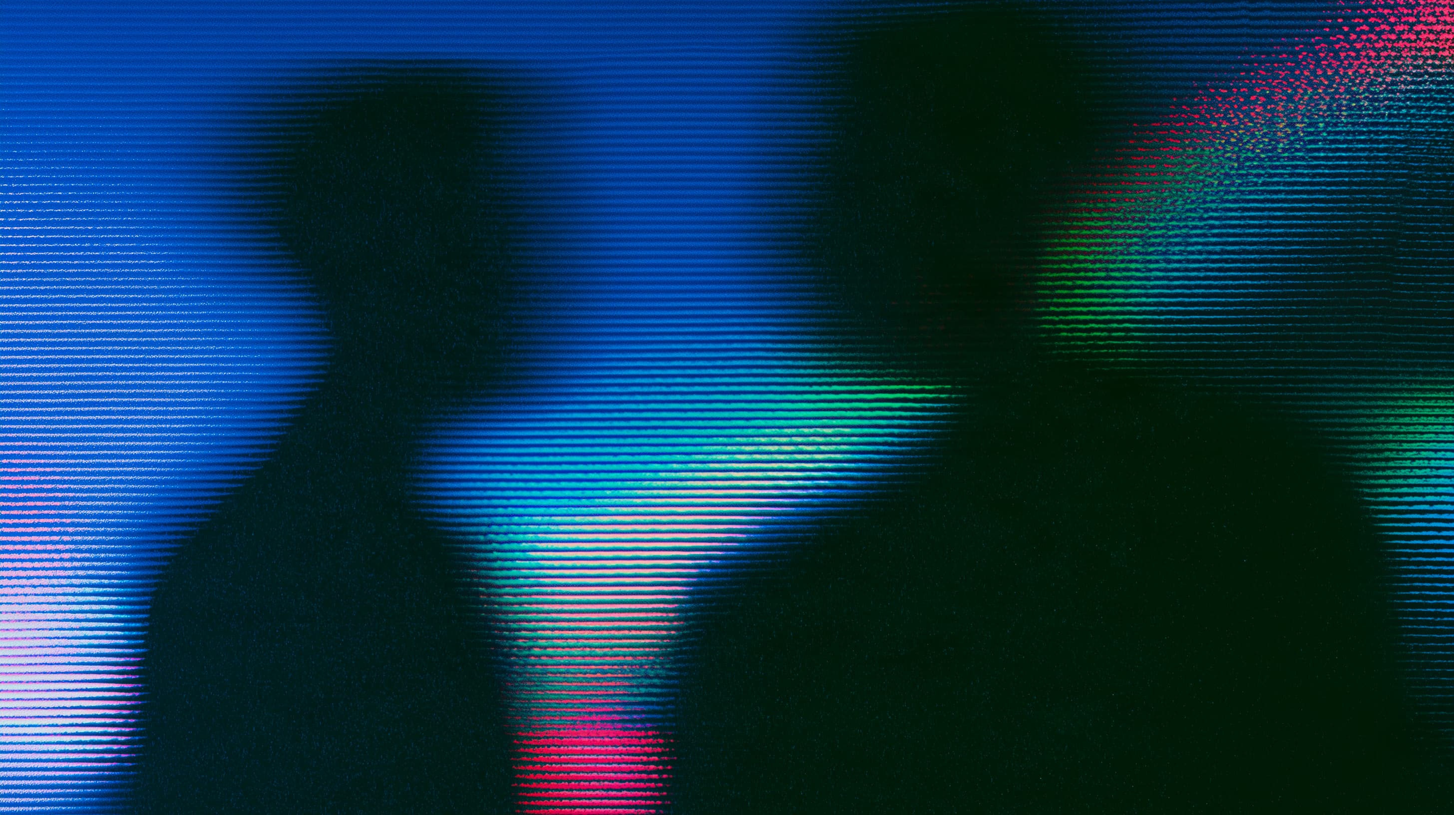 Abstract blue, green, and pink light patterns on a dark background
